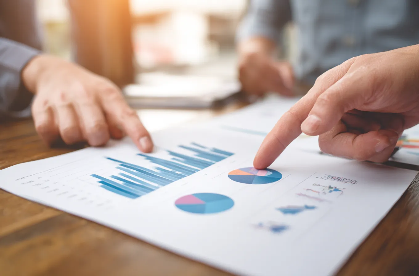 mindshow_three_hands_pointing_at_graphs_and_charts