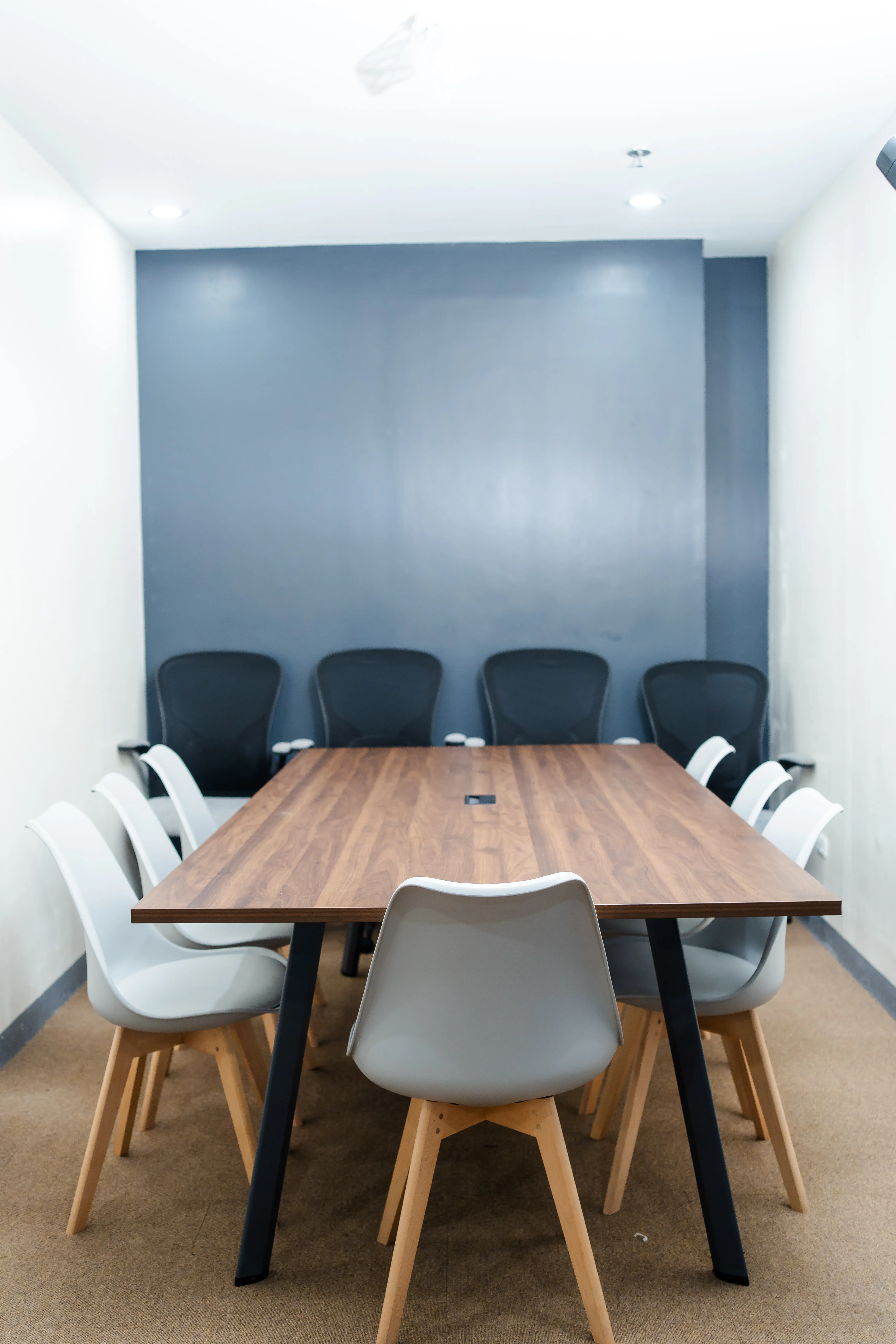 Meeting room with a long wooden table and chairs in the eComia office