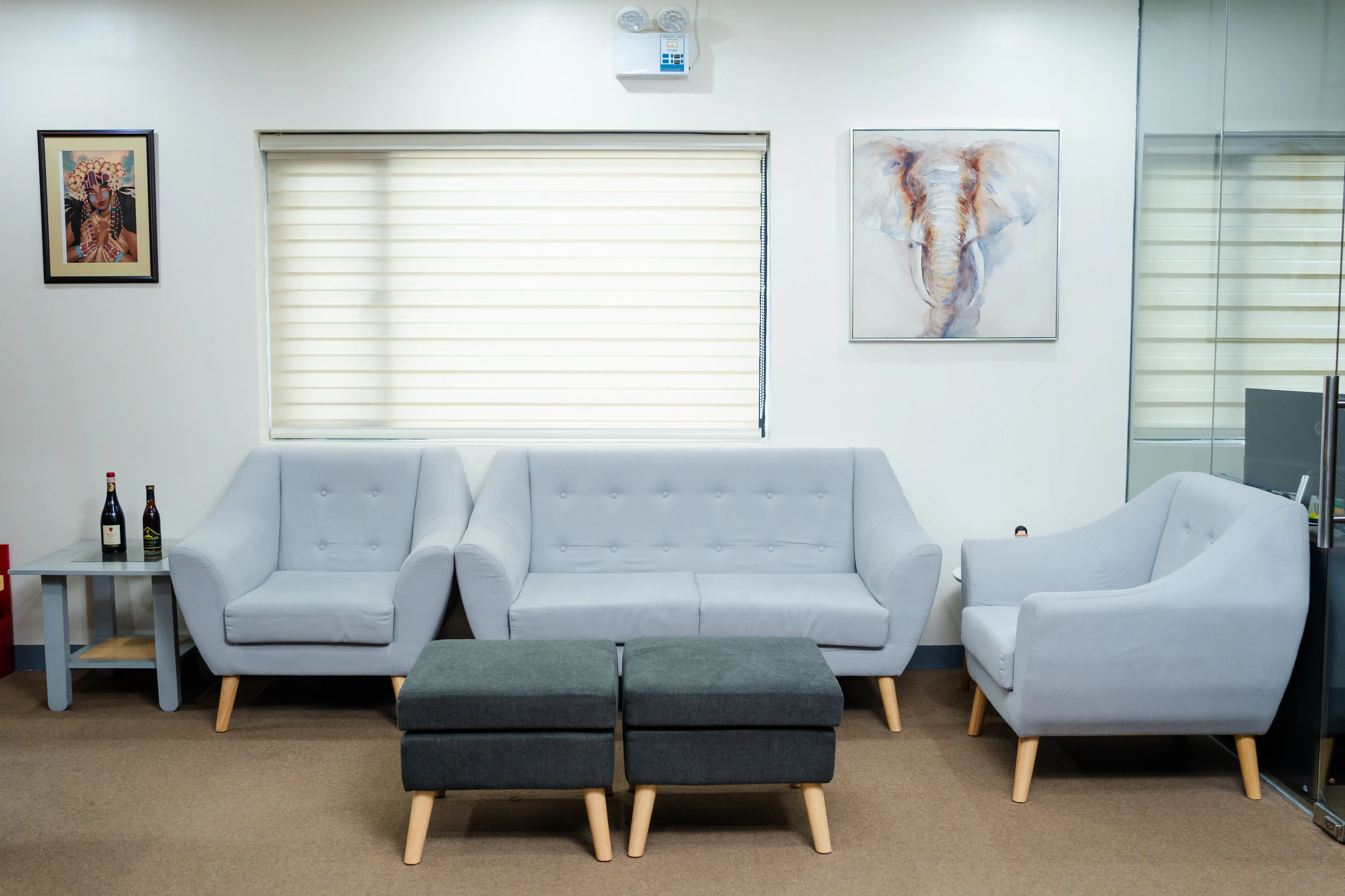 Lobby seating area with gray sofas and armchairs in the eComia office