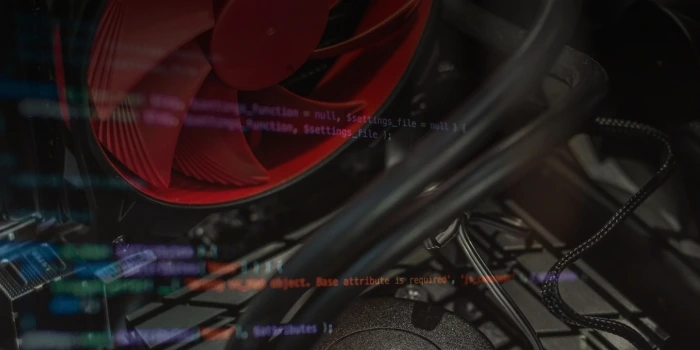 The inside of a computer case lit red, with faint lines of code overlaid