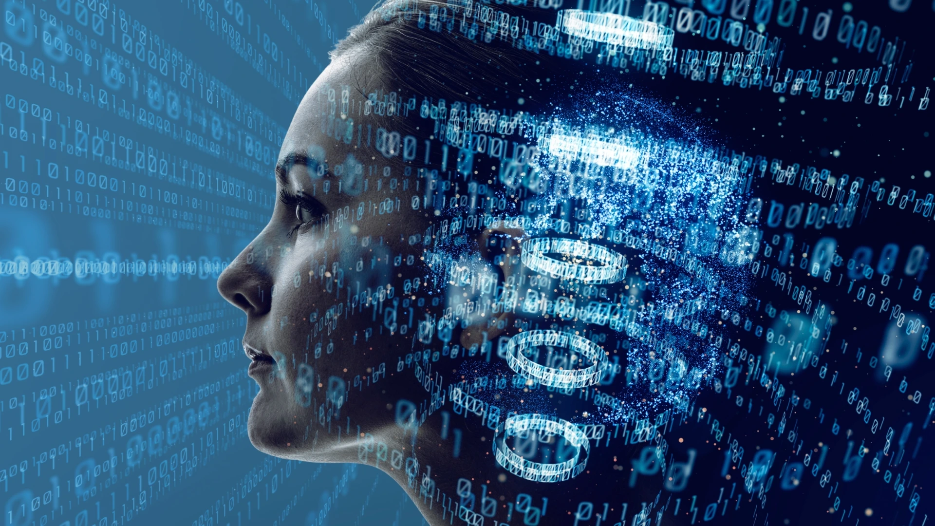 A profile in blue light dissolving into streams of binary digits
